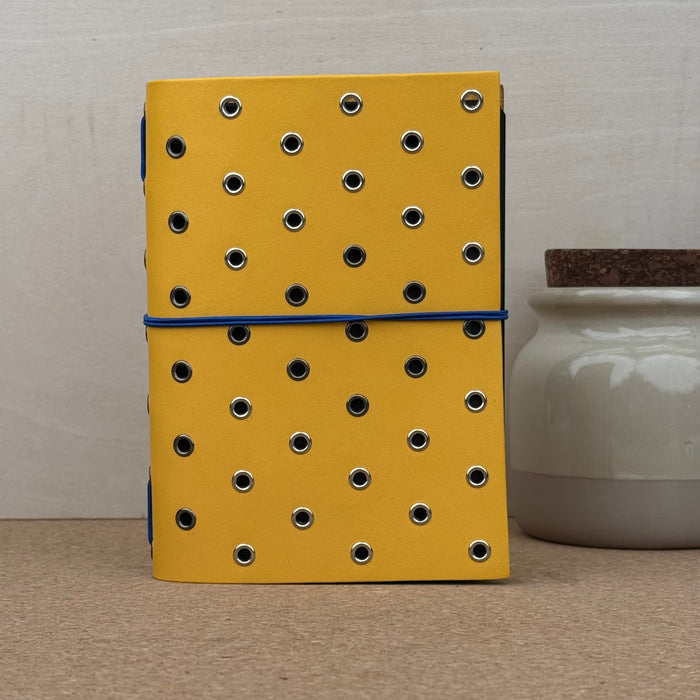 Imperfect Concepts Max Notebook - A6 Bifold - Zest w/ Mixed Grommets - Dark Blue Band