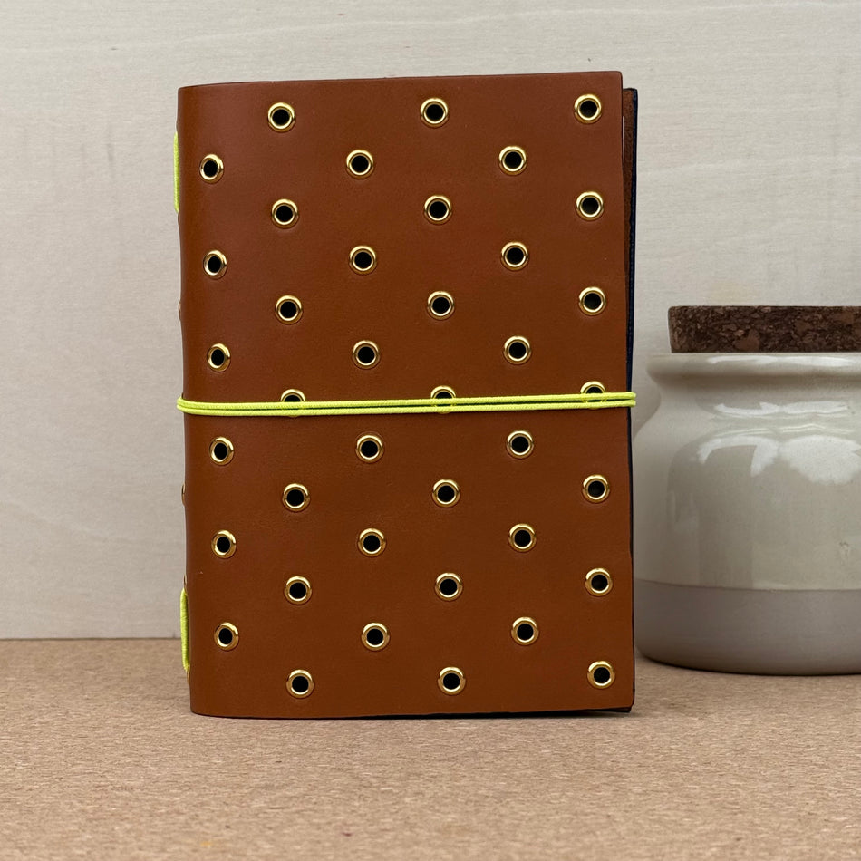 Imperfect Concepts Max Notebook - A6 Bifold - Cognac w/ Gold Grommets and Painted Edge